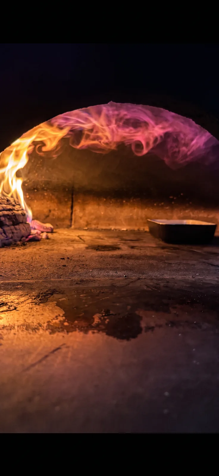 Basilico wood-fired oven with flame inside the restaurant